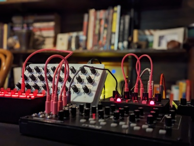 Electronic musical instruments with glowing LEDs and pink cables